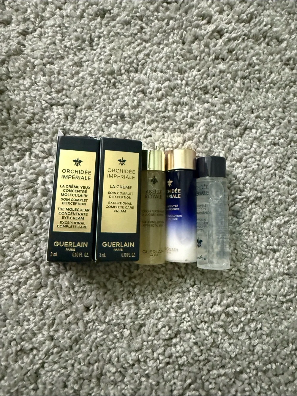 GUERLAIN gold and cream skincare set with woven clutch